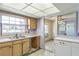 Kitchen with light wood cabinets, double sink, and view into dining area at 1716 Sprucewood Ln, Orlando, FL 32818