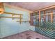Unfinished sunroom with concrete floor and shelving at 1716 Sprucewood Ln, Orlando, FL 32818