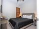 Bedroom with gray upholstered bed and dark bedding at 172 Villa Domani Cir, Davenport, FL 33896