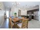Bright dining area with wood table and chairs, open to the kitchen at 172 Villa Domani Cir, Davenport, FL 33896