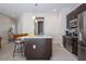 Modern kitchen island with stainless steel appliances and breakfast bar at 172 Villa Domani Cir, Davenport, FL 33896