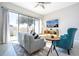 Living room with gray sofa, teal accent chair, and sliding glass doors at 172 Villa Domani Cir, Davenport, FL 33896