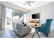 Living room with gray sofa, teal accent chair, and sliding glass doors at 172 Villa Domani Cir, Davenport, FL 33896