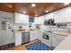 White kitchen with stainless steel appliances and wood ceiling at 2555 Gabriel Rd, Fort Meade, FL 33841