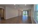 Bright living room featuring wood-look tile floors and sliding glass doors leading to the backyard at 2683 Hinoki Cypress Pl, Sanford, FL 32773