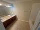 Bathroom boasts a double vanity, tub and tile flooring at 3151 Sinclair St # 104, Orlando, FL 32835