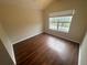 Bright bedroom with large window and wood-look flooring at 3151 Sinclair St # 104, Orlando, FL 32835