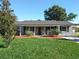 Newly renovated house with gray exterior, covered porch, and well-manicured lawn at 3607 Datura Ct, Winter Park, FL 32792