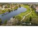 Aerial view of a golf course and a lake in a residential area at 8019 Arcadian Ct, Mount Dora, FL 32757