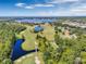 Golf course community with lake and lush landscaping at 8019 Arcadian Ct, Mount Dora, FL 32757
