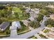 Aerial view showcasing a house's location in a community near a golf course at 8019 Arcadian Ct, Mount Dora, FL 32757