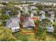 Aerial view of a house with a screened-in porch in a residential neighborhood at 8019 Arcadian Ct, Mount Dora, FL 32757