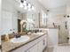 Bathroom with double vanity, granite countertop, and a glass shower at 8019 Arcadian Ct, Mount Dora, FL 32757