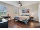 Relaxing bedroom with hardwood floors, large windows, and a cozy bed at 8019 Arcadian Ct, Mount Dora, FL 32757