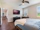 Main bedroom with wood floors, large windows and view into dining area at 8019 Arcadian Ct, Mount Dora, FL 32757