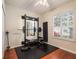 Home gym with wall-mounted rack, weights, and mirrored wall at 8019 Arcadian Ct, Mount Dora, FL 32757