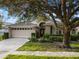 One-story home with attached garage and manicured lawn at 8019 Arcadian Ct, Mount Dora, FL 32757