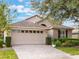 One-story home with attached garage and manicured lawn at 8019 Arcadian Ct, Mount Dora, FL 32757