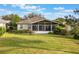 Single-story home with a large sunroom and lush landscaping at 8019 Arcadian Ct, Mount Dora, FL 32757