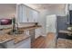 Modern kitchen with white cabinets, granite countertops, and stainless steel appliances at 8019 Arcadian Ct, Mount Dora, FL 32757