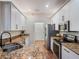 Modern kitchen with stainless steel appliances and granite countertops at 8019 Arcadian Ct, Mount Dora, FL 32757