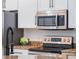 Modern kitchen featuring stainless steel Samsung appliances and granite countertops at 8019 Arcadian Ct, Mount Dora, FL 32757