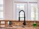 Kitchen sink with modern black gooseneck faucet and granite countertop at 8019 Arcadian Ct, Mount Dora, FL 32757