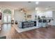 Open concept living and kitchen area with hardwood floors and a breakfast bar at 8019 Arcadian Ct, Mount Dora, FL 32757