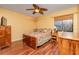 Well-lit bedroom with wood flooring, ceiling fan, and floral bedding at 872 Huckleberry Ln, Winter Springs, FL 32708