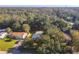 Aerial view of house nestled amongst trees with a driveway and yard at 121 Ellison Ave, New Smyrna Beach, FL 32168