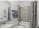Clean bathroom with granite countertop, bathtub, and shower at 1708 Columbus Path, St Cloud, FL 34771