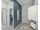 Hallway with blue accent wall, mirror, and access to bedrooms at 1708 Columbus Path, St Cloud, FL 34771