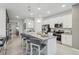 Open concept kitchen island with seating and stainless steel appliances at 1708 Columbus Path, Saint Cloud, FL 34771