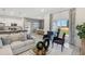 Open-concept living room with sectional sofa and adjacent kitchen at 1708 Columbus Path, St Cloud, FL 34771