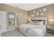 Bright main bedroom with king-size bed and ensuite bathroom at 1708 Columbus Path, St Cloud, FL 34771