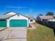 Front view of house showing two-car garage and a side yard with landscaping at 2435 Turpin Dr, Orlando, FL 32837