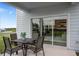 Covered patio with seating area and sliding glass doors at 2555 Winsome Way, Davenport, FL 33896