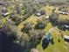 Aerial view showing home, outbuildings, and waterfront location at 2607 Osceola Bluff Ln, Geneva, FL 32732