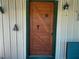 Rustic wooden front door with unique hardware and green trim at 2607 Osceola Bluff Ln, Geneva, FL 32732