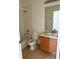 Clean bathroom with a tub, toilet, and vanity with wood cabinets at 3660 Wilshire Way Rd # 260, Orlando, FL 32829