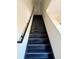 Modern staircase with black railings leading to the second floor at 3660 Wilshire Way Rd # 260, Orlando, FL 32829