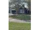 Gray house with a white garage door and landscaping at 378 Southern Charm Dr, Orlando, FL 32807
