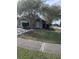 Gray house with a white garage door and landscaping at 378 Southern Charm Dr, Orlando, FL 32807