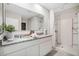 Double vanity bathroom with granite countertops and a shower at 418 St Johns Ln, Kissimmee, FL 34759