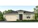 One-story home with a neutral color scheme and a two-car garage at 418 St Johns Ln, Kissimmee, FL 34759