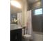 Bathroom with a shower/tub combo, modern vanity, and window at 9859 Winnington St, Orlando, FL 32832