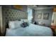 Serene bedroom with a tufted headboard and neutral decor at 9859 Winnington St, Orlando, FL 32832