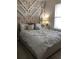 Cozy bedroom with a plush bed, accent wall, and soft lighting at 9859 Winnington St, Orlando, FL 32832