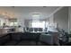 Open dining room with chandelier and views of living room and kitchen at 9859 Winnington St, Orlando, FL 32832