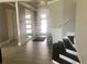 Entryway with gray walls, tiled floor, and staircase at 9859 Winnington St, Orlando, FL 32832